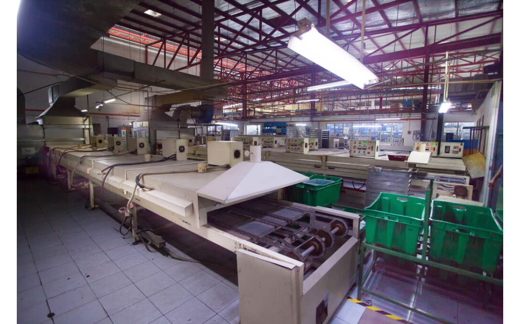 Industrial conveyor oven used to cure and dry screen-printed inks on silicone rubber components.