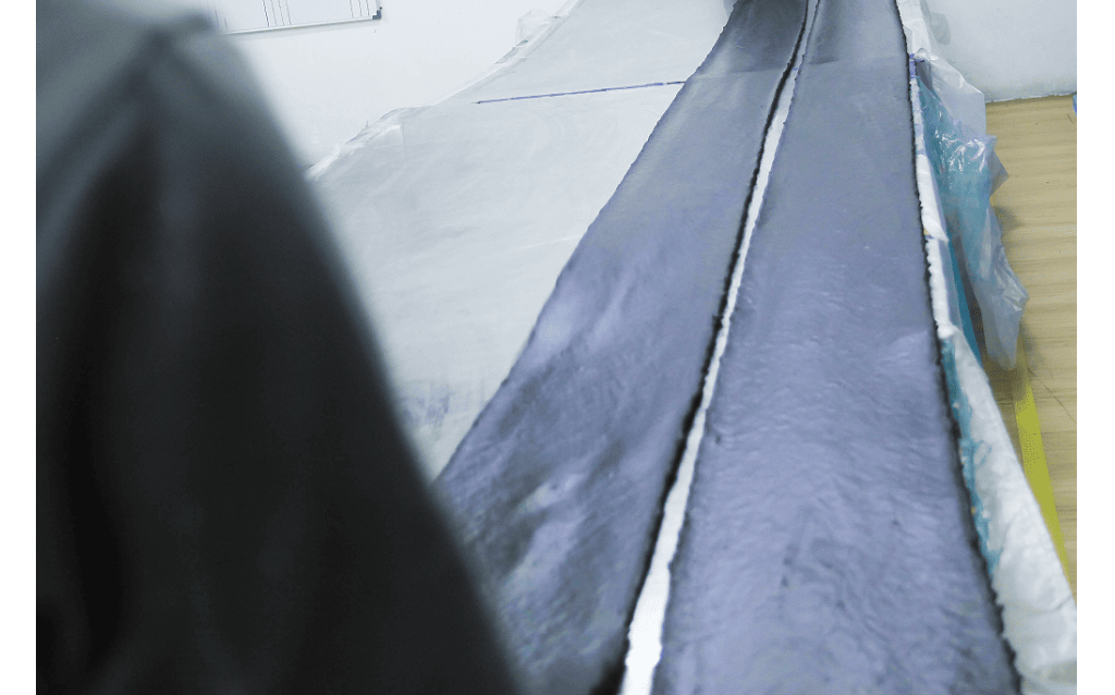 High-tensile natural rubber raw sheets and molded vibration dampers at the NK Rubber plant.