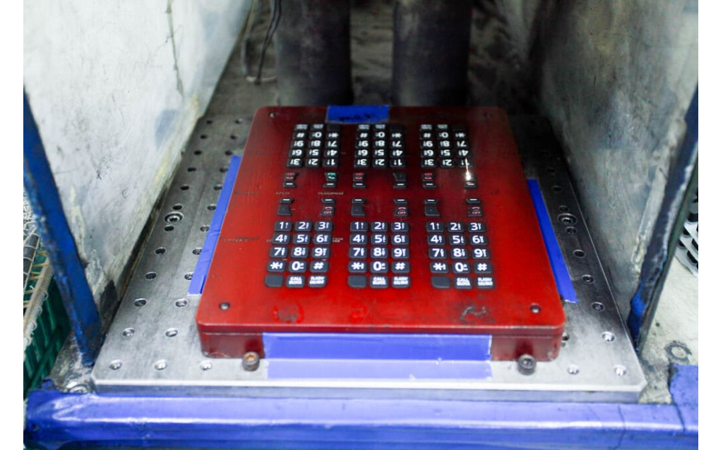 Quality control engineer conducting an optical inspection of laser-etched symbols for dimensional accuracy.