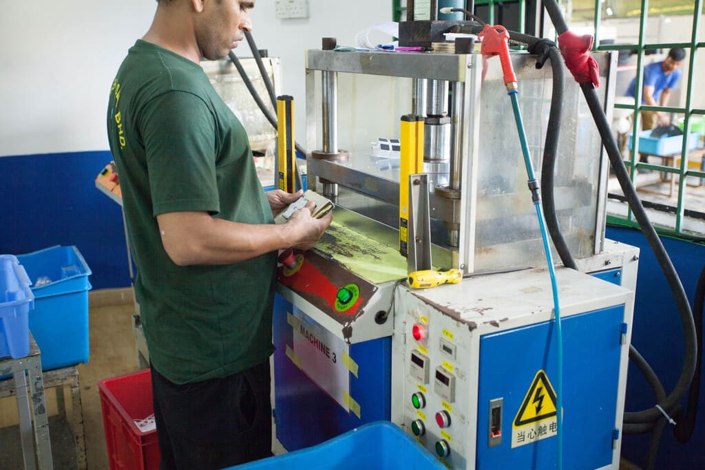 Application of high-bond double-sided 3M adhesive backing to custom molded rubber profiles.