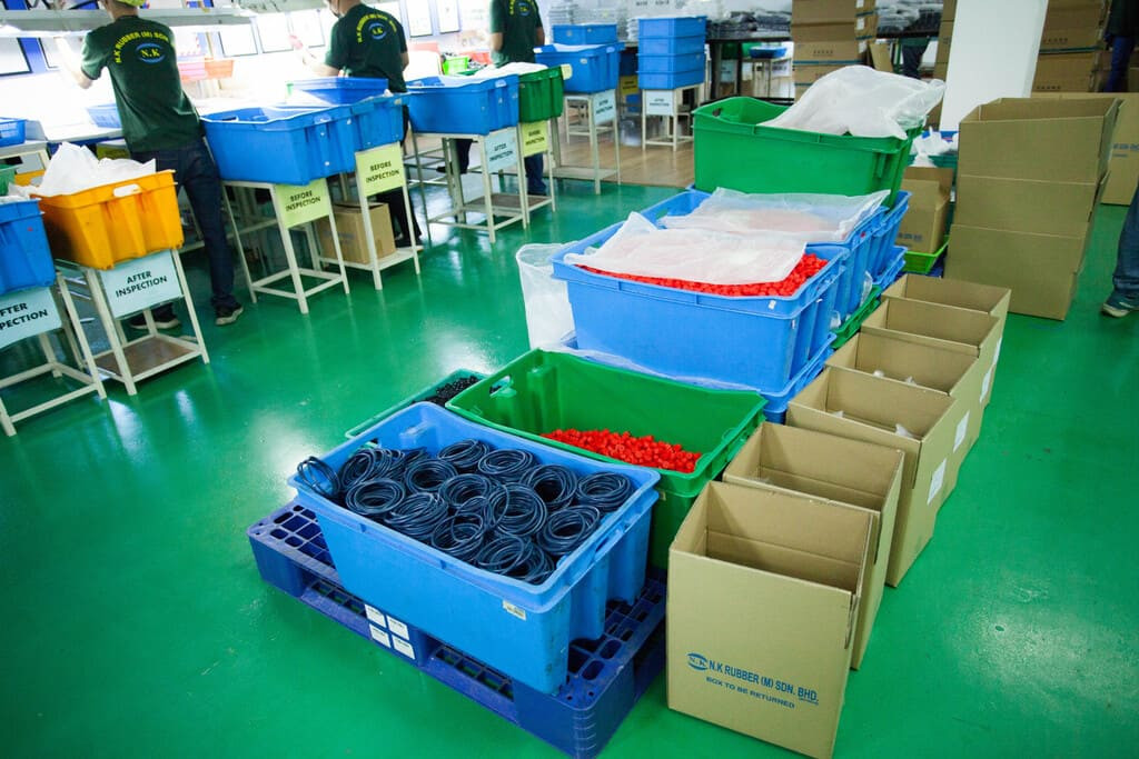 Final batch inspection and custom barcode labeling of fully completed rubber product kits.