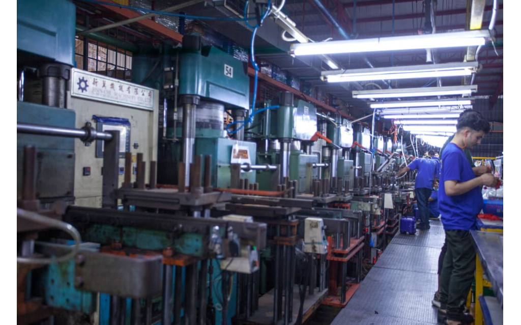 Post-molding operations showing trimming and precision de-flashing of rubber parts.